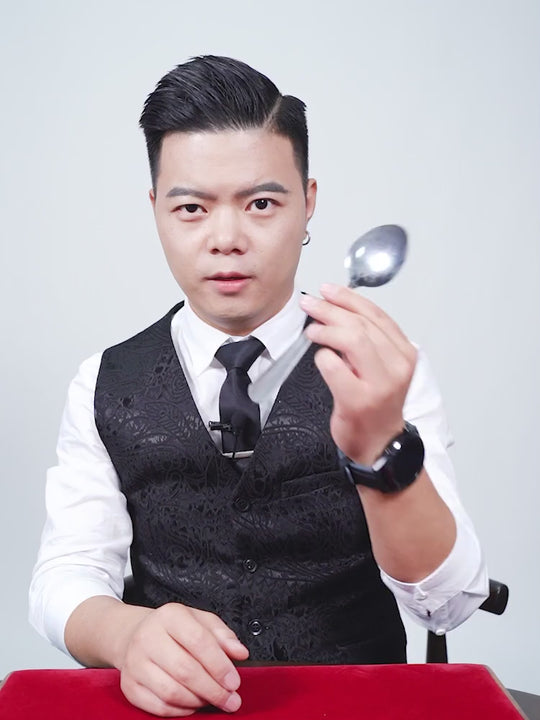 Bending Spoon demo: a silver spoon appears to curve slowly in the magician's hands.